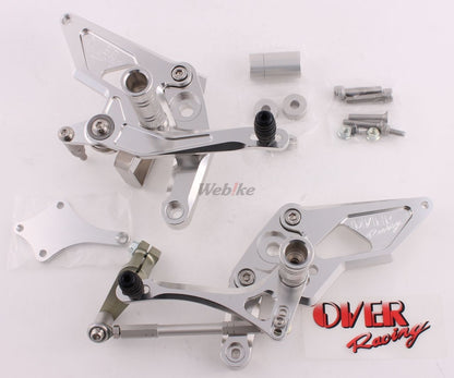 Over Racing rearsets with four adjustable positions installed on a Honda Grom motorcycle, showcasing durable metal construction and sleek design.