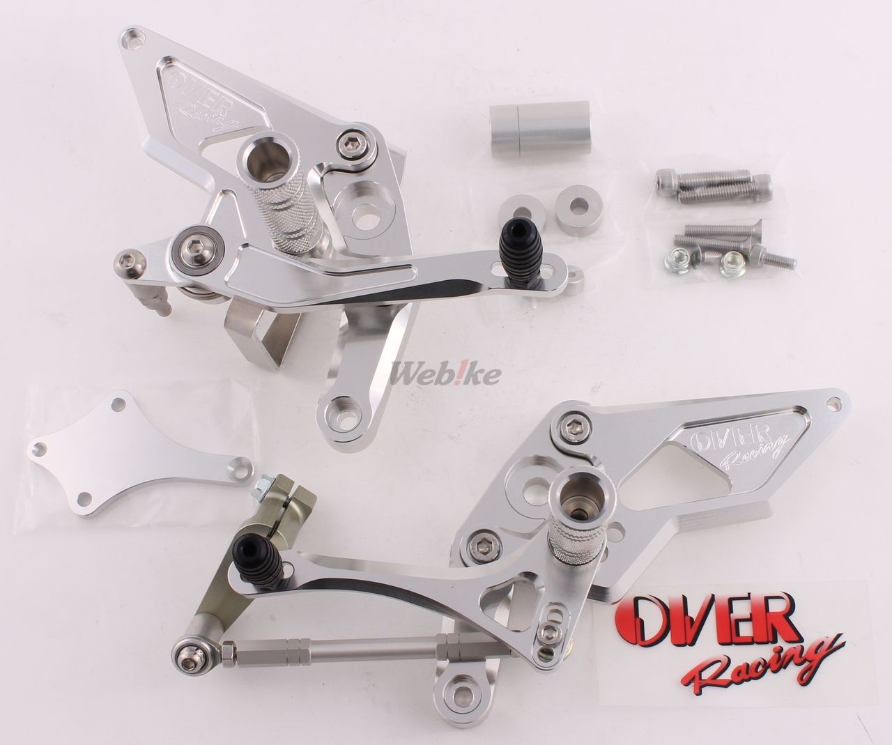 Over Racing rearsets with four adjustable positions installed on a Honda Grom motorcycle, showing the black metal footpeg and lever.