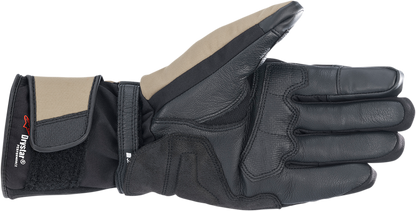 Alpinestars Denali Aerogel Drystar gloves in black, dark khaki, and fluo red with reinforced palms and adjustable wrist straps.