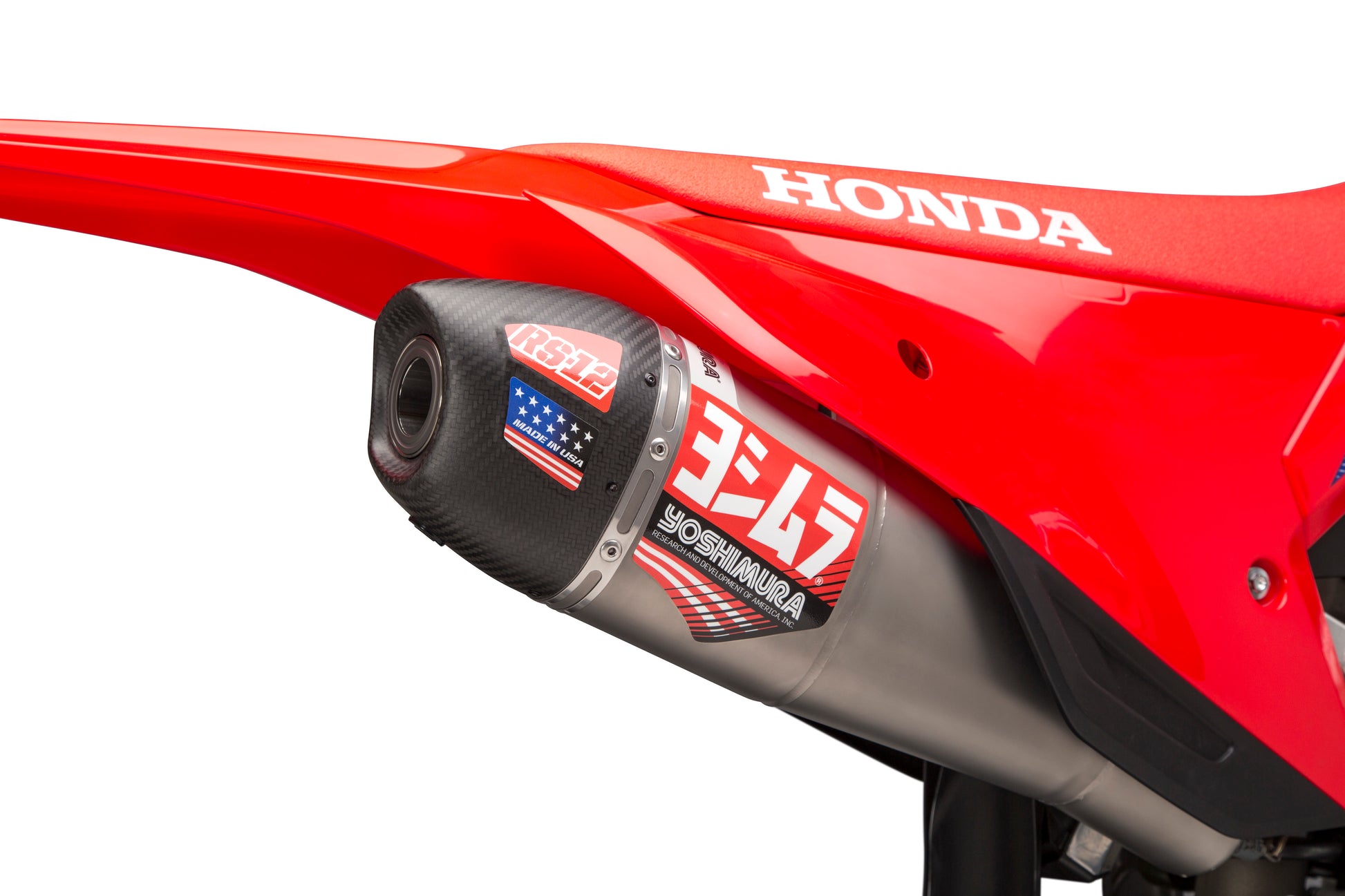 YOSHIMURA RS-12 slip-on exhaust for Honda CRF450R and RX dirt bikes, showcasing the sleek metal muffler and mounting hardware.