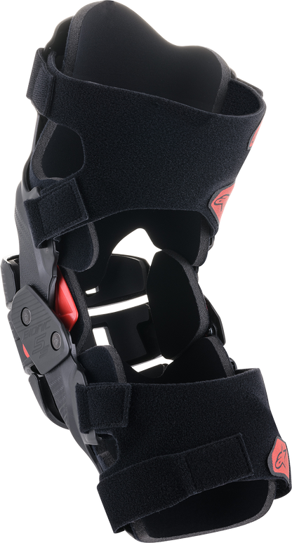 Alpinestars Youth Bionic 5S Knee Braces in black and red with adjustable straps and protective padding for motocross.