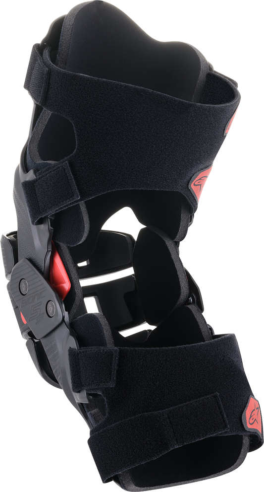Alpinestars Youth Bionic 5S Knee Braces in black and red with adjustable straps and protective padding for motocross.