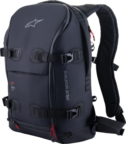 Alpinestars AMP-7 backpack in black with multiple compartments, adjustable straps, and branding visible on the front.