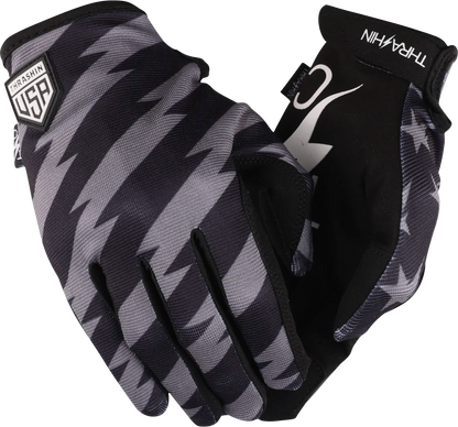 Black and gray Thrasin Supply Co. Stars & Bolts Stealth Gloves in medium size shown with detailed star and bolt design.