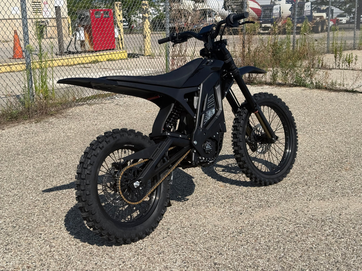 E Ride Pro SR electric dirt bike with 25KW motor, rugged frame, knobby tires, and sleek black design for off-road riding.