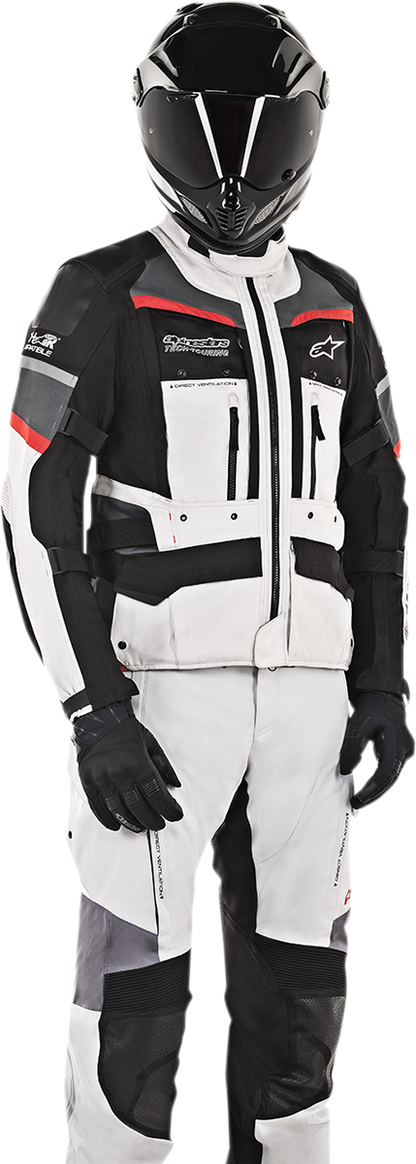 Alpinestars Andes Pro Drystar® motorcycle jacket in gray, black, and red with protective features, displayed on a hanger.