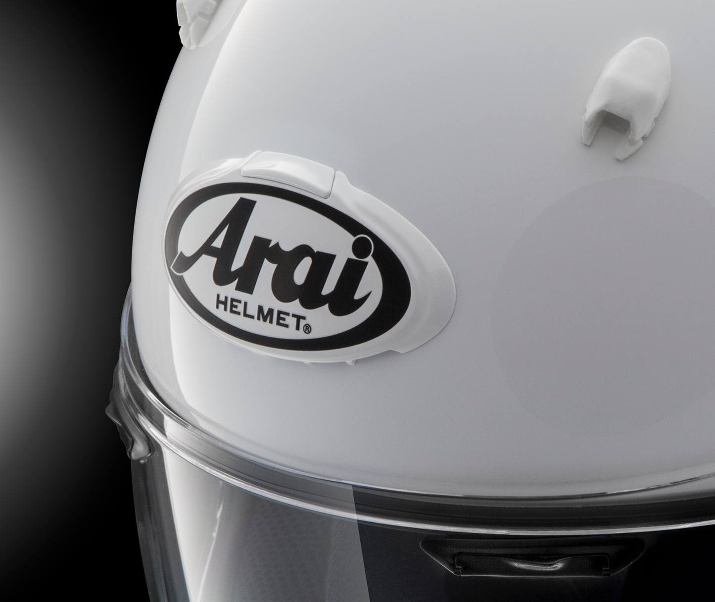 White and gray Arai helmet with 3D Arai logo duct, featuring sleek design and branding detail from Arai Helmets.