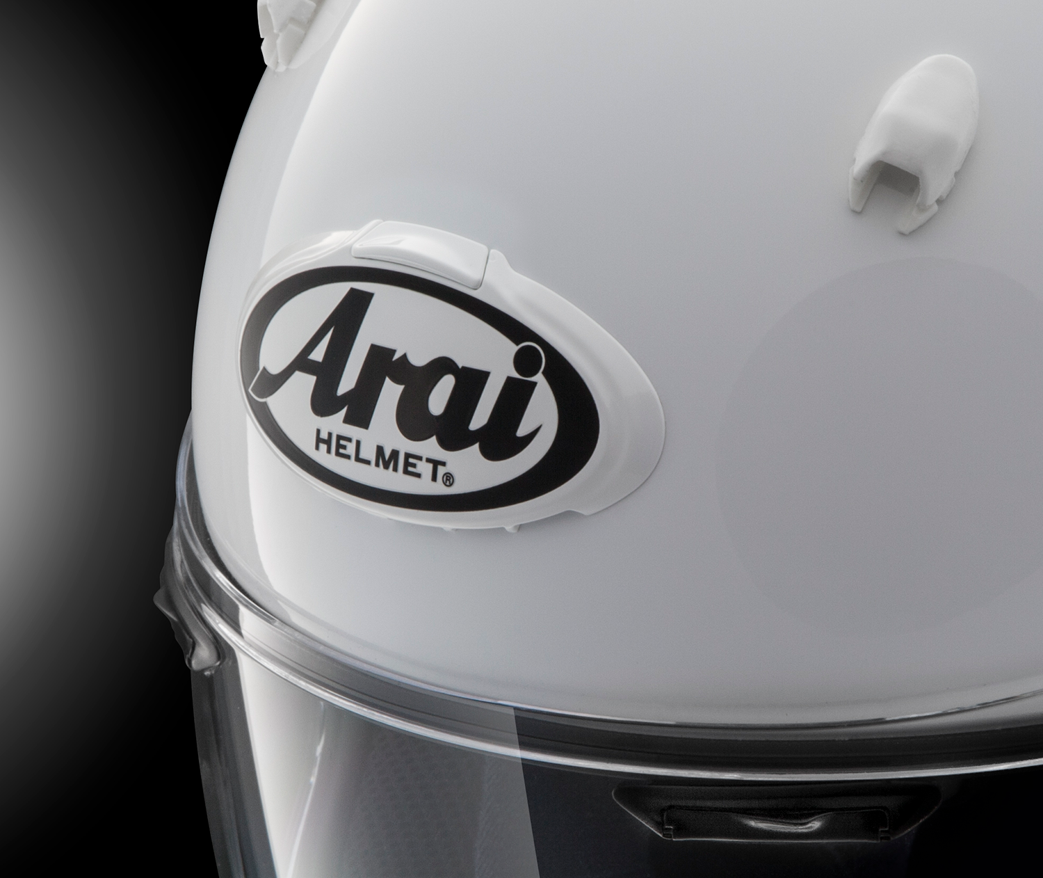 White and gray Arai helmet with 3D Arai logo duct, featuring sleek design and branding detail from Arai Helmets.