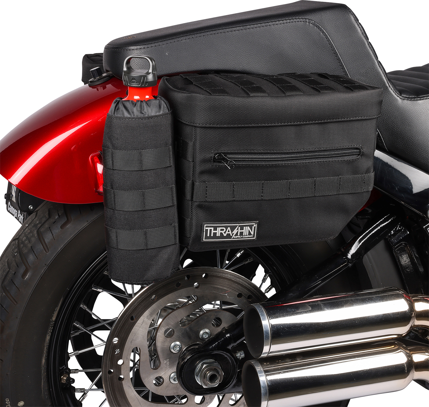 Black THRASHIN SUPPLY CO. Essential Saddlebags TSB-0006 with 10-liter capacity, shown mounted on a motorcycle for storage.
