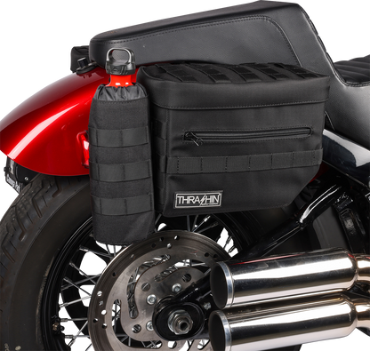 Black THRASHIN SUPPLY CO. Essential Saddlebags TSB-0006 with 10-liter capacity, shown mounted on a motorcycle for storage.