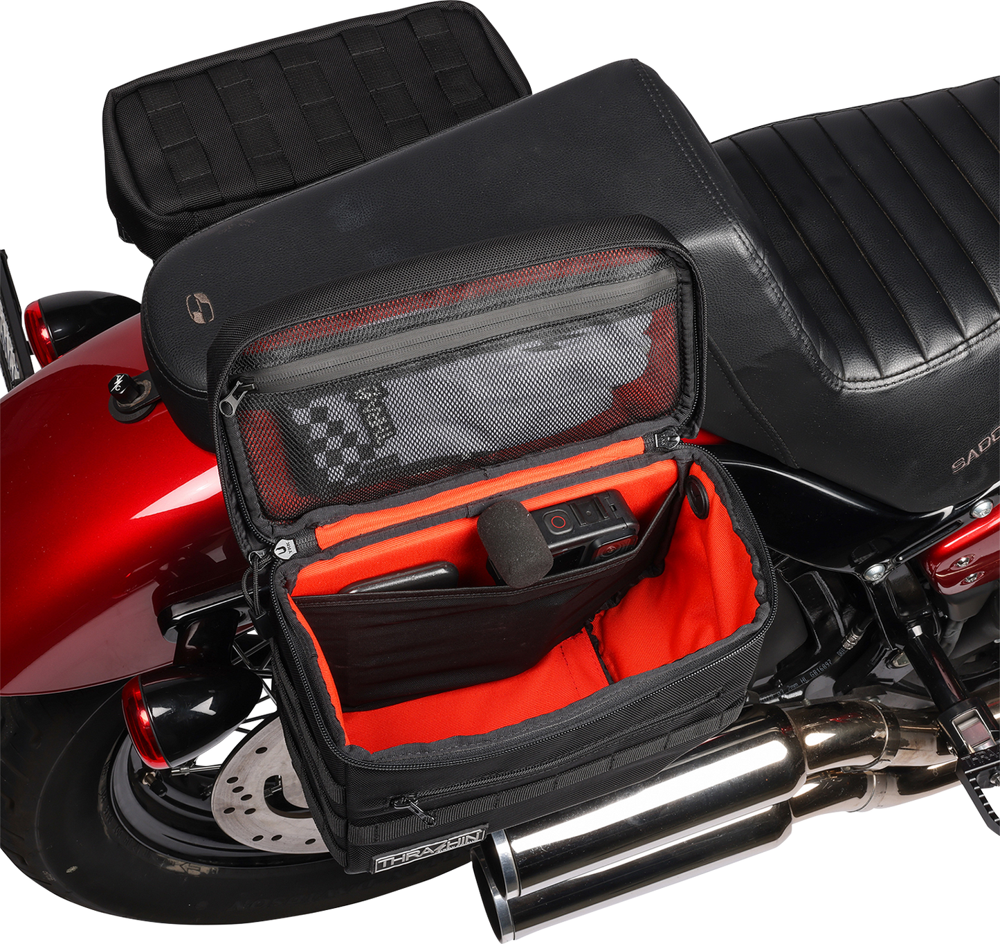 Black THRASHIN SUPPLY CO. Essential Saddlebags TSB-0006 with 10-liter capacity, shown mounted on motorcycle for storage.