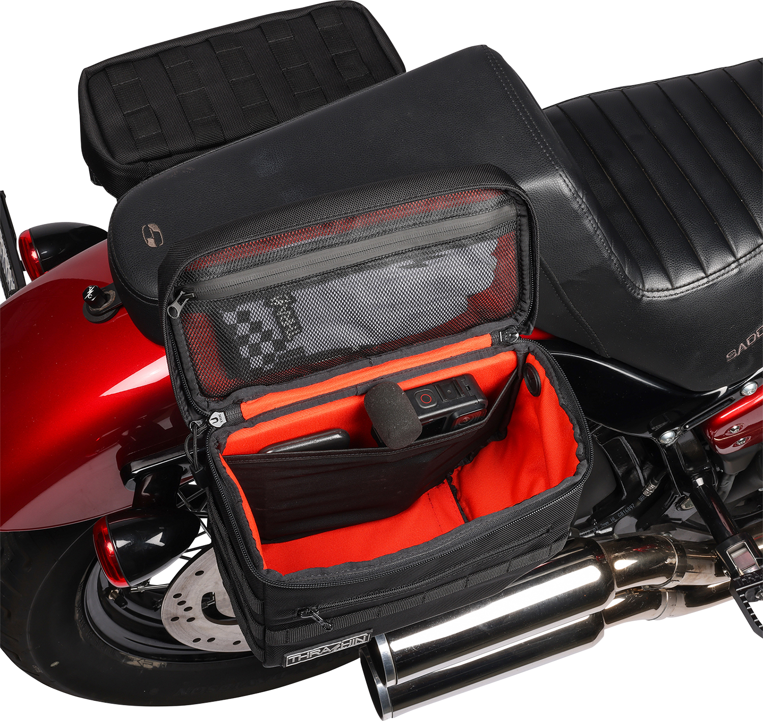 Black THRASHIN SUPPLY CO. Essential Saddlebags TSB-0006 with 10-liter capacity, shown mounted on motorcycle for storage.