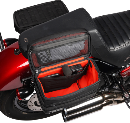 Black THRASHIN SUPPLY CO. Essential Saddlebags TSB-0006 with 10-liter capacity, shown mounted on motorcycle for storage.