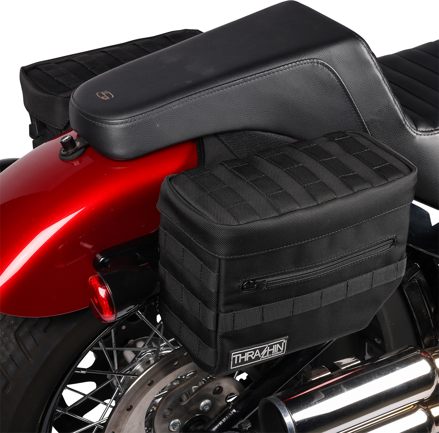 Black THRASHIN SUPPLY CO. Essential Saddlebags TSB-0006 with 10-liter capacity, shown mounted on a motorcycle for storage.