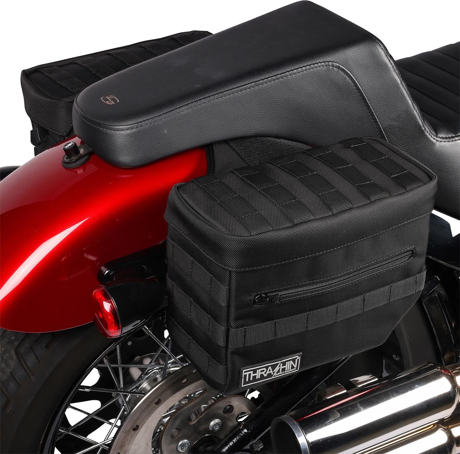 Black THRASHIN SUPPLY CO. Essential Saddlebags TSB-0006 with 10-liter capacity, shown mounted on a motorcycle for storage.