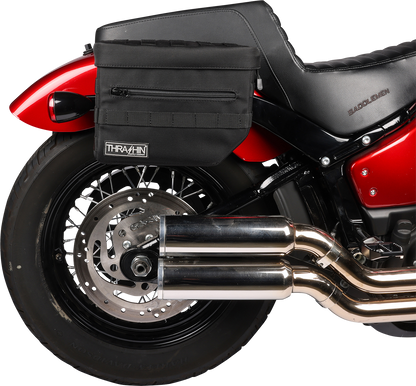 Black THRASHIN SUPPLY CO. Essential Saddlebags with 10-liter capacity, showing durable leather material and secure buckles.