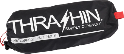 Black Thrasin Supply Co. Mission rain pants in size S/M laid flat showing the waterproof fabric and slim fit design.