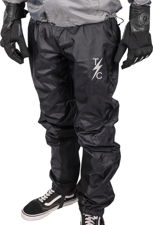 Black THRASHIN SUPPLY CO. Mission Rain Pants in size L/XL, showing waterproof material and adjustable waistband.