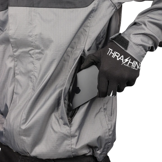 Black and gray THRASHIN SUPPLY CO. Mission WP rain jacket in medium, waterproof fabric with hood and adjustable cuffs.