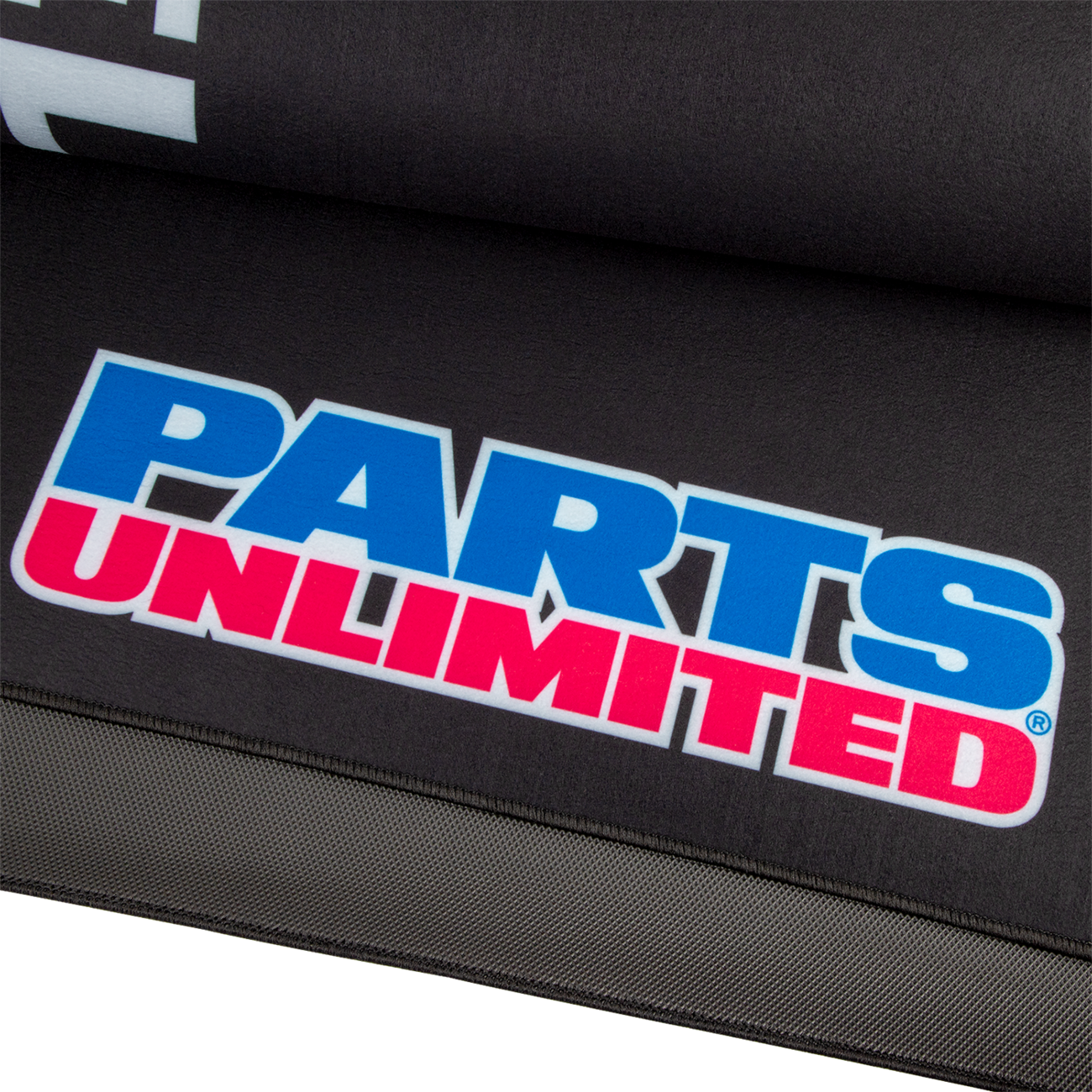 Large PARTS UNLIMITED absorbent pit pad with logo, designed for shop and pit area protection, shown in the image.