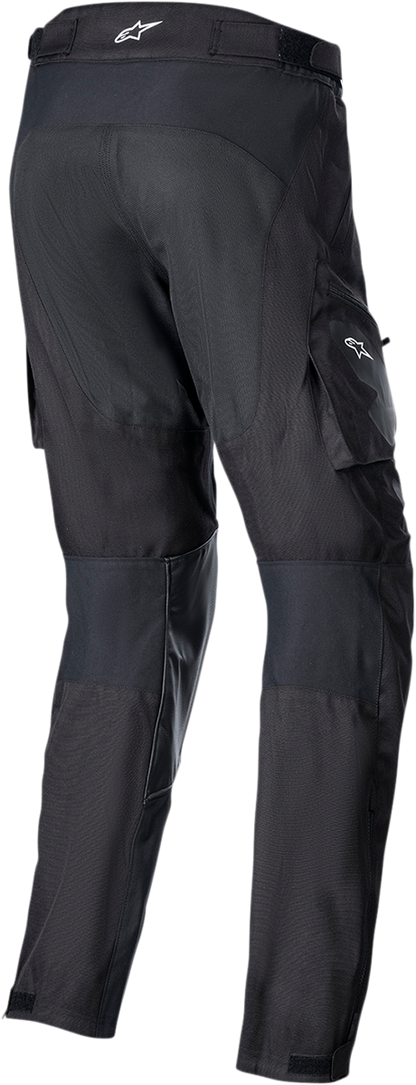 Black ALPINESTARS Venture XT over-the-boot motorcycle pants, medium size, with reinforced areas and adjustable straps.