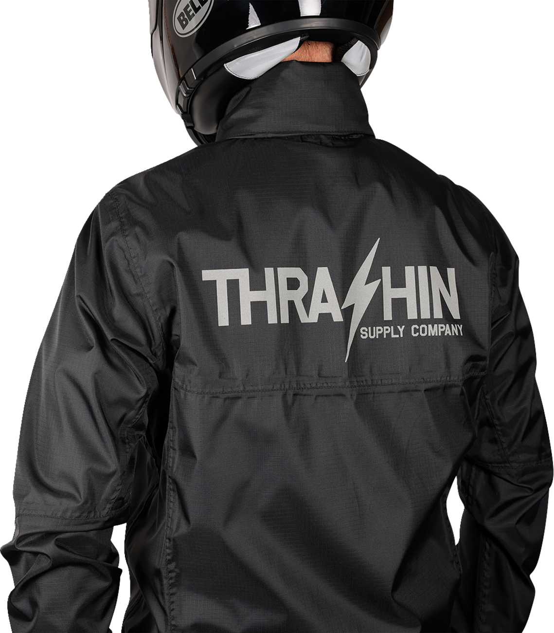 Black THRASHIN SUPPLY CO. Mission WP rain jacket in medium size, showcasing waterproof material and adjustable hood.