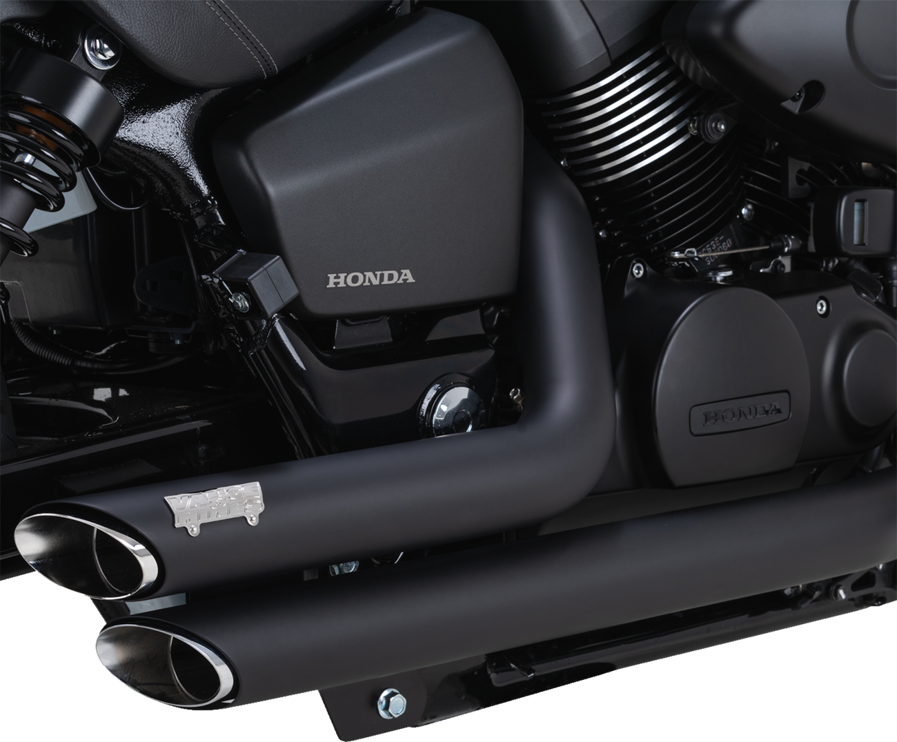 Vance & Hines Shortshots Staggered Exhaust System in black mounted on a motorcycle, showcasing the sleek, performance-oriented design.
