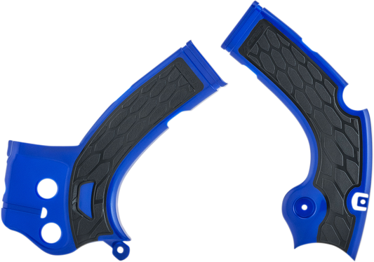 A close-up of ACERBIS X-Grip frame guards in blue and black mounted on a motorcycle frame.