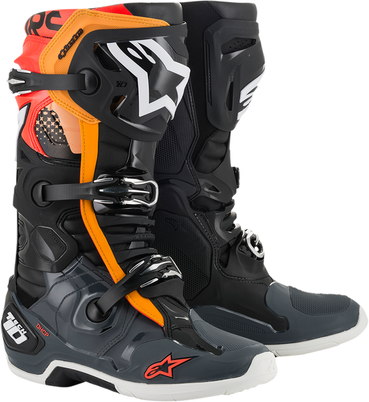 Alpinestars Tech 10 motorcycle boots in black, gray, orange, and fluorescent red displaying the protective design and branding.