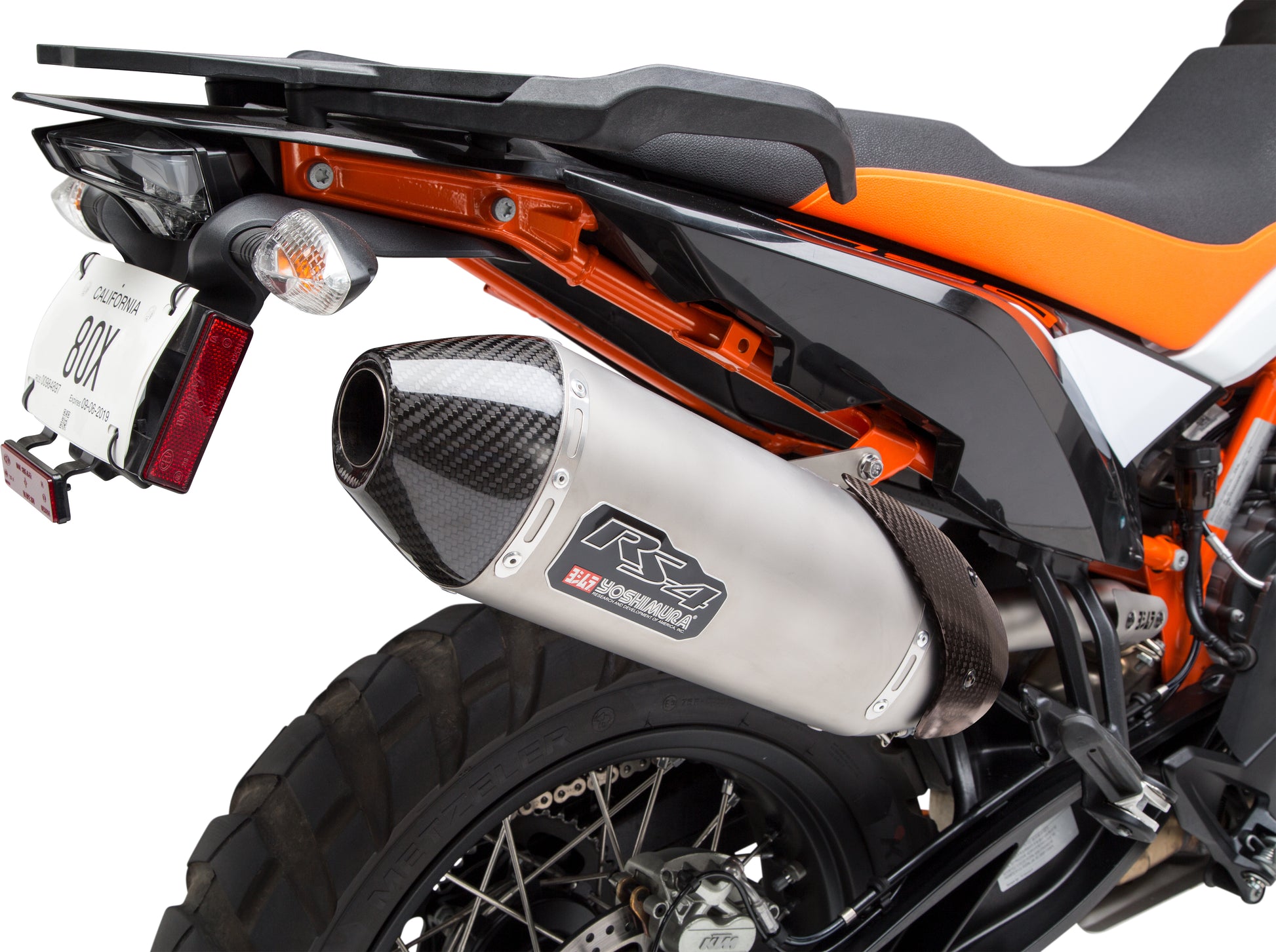 YOSHIMURA RS-4 Street Slip-On Exhaust System with stainless steel and carbon fiber components, mounted on a motorcycle.
