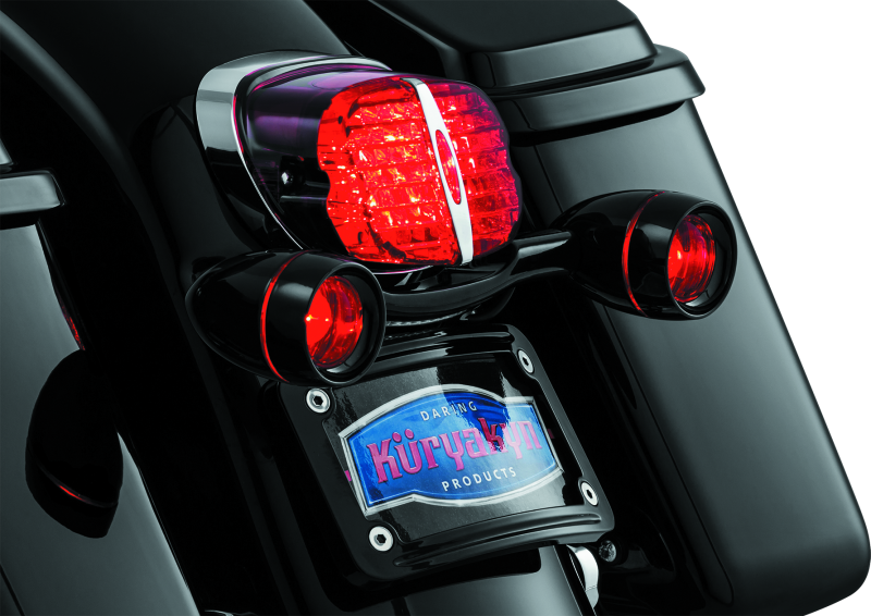 Kuryakyn Deep Dish Turn Signal Bezels with Red Lenses for Harley-Davidson motorcycles, featuring chrome finish and round design.