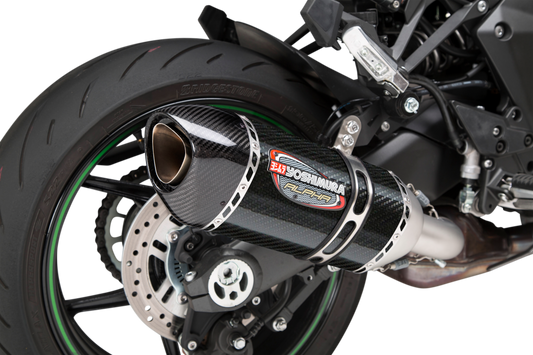 YOSHIMURA RS-12 ADV Street Alpha slip-on exhaust for Kawasaki with matte carbon fiber end cap, showcasing sleek metallic and carbon finish.