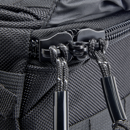 Black Biltwell Exfil-18 saddlebags attached to a motorcycle, showcasing durable leather bags with metal buckles for secure storage.