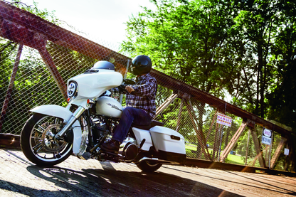 Kuryakyn chrome oil cooler cover for Harley Davidson Touring models, showcasing polished metal design and fitting securely.