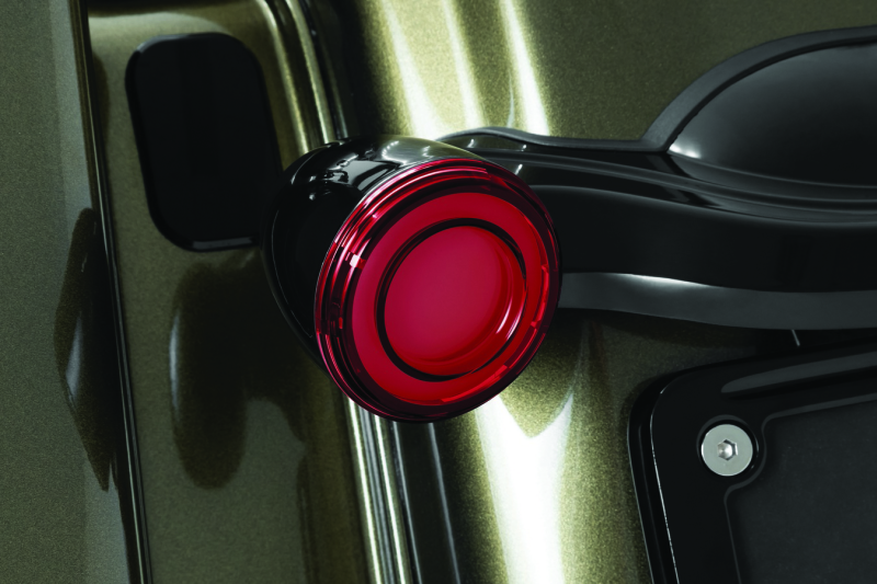 Kuryakyn Tracer LED rear turn signal insert for Harley Davidson Road King Special motorcycle, showing illuminated red LED lights.