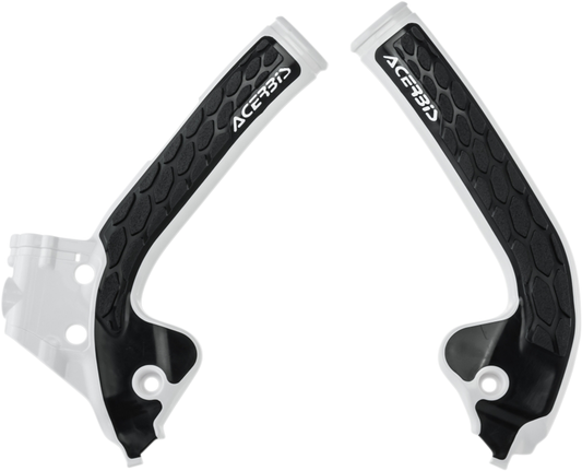 Acerbis X-Grip frame guards in white and black installed on a motorcycle frame, providing protection and style.