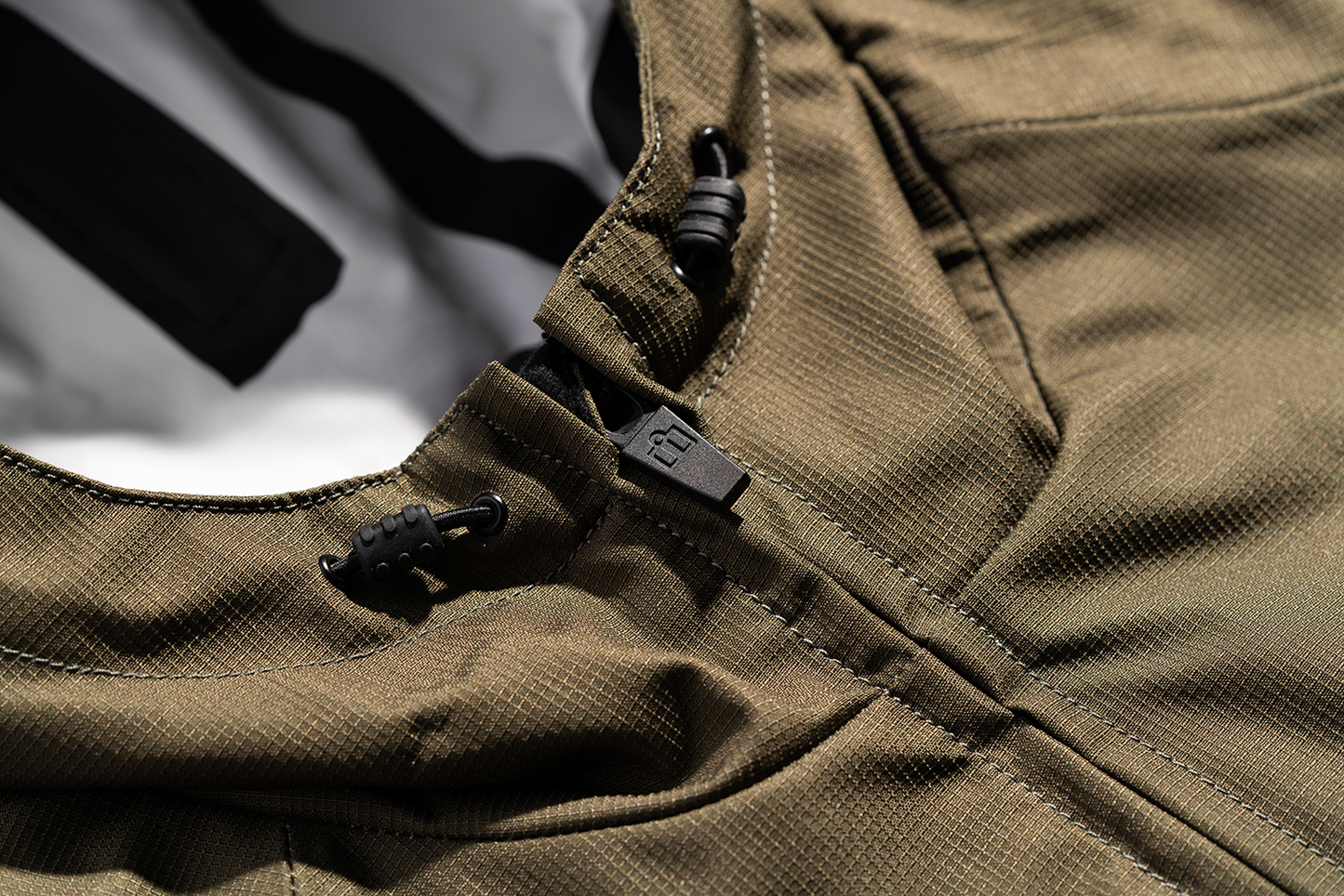Bill's Exhausts ICON PDX3™ Olive Jacket in Small, showcasing a stylish, lightweight jacket with a zip-up front and adjustable hood.
