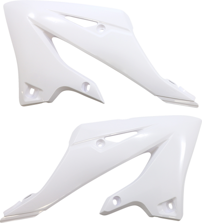 White Acerbis standard replacement body kit for motorcycles, shown on a worktable with tools and parts.