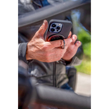 Bill's Exhausts SP CONNECT phone mount attachment showing secure mount with a smartphone attached, designed for vehicle use.