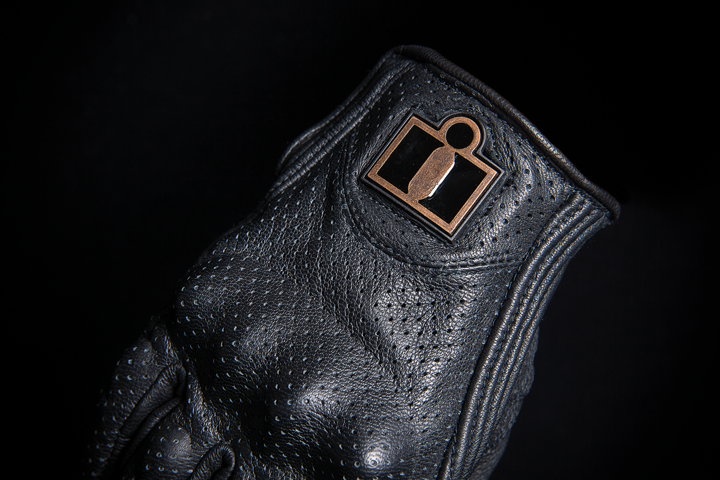 Black ICON Women's Pursuit Classic™ perforated gloves, small size, showing the textured perforated design and snug fit.