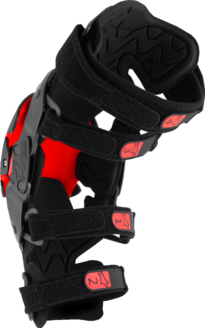 Alpinestars RK-1 Plasma knee braces in black and red with adjustable straps, size small/medium, designed for knee protection.