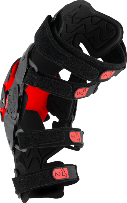 Alpinestars RK-1 Plasma knee braces in black and red with adjustable straps, size small/medium, designed for knee protection.