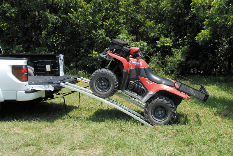 QuadBoss arched pair ramps for powersports vehicles, measuring 12x89 inches, shown in a natural outdoor setting.
