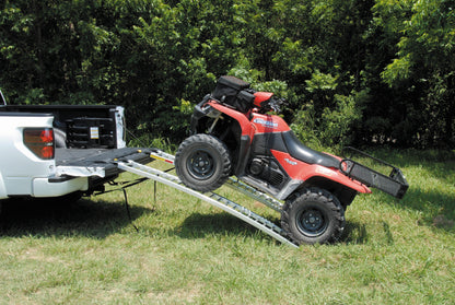QuadBoss arched pair ramps for powersports vehicles, measuring 12x89 inches, shown in a natural outdoor setting.