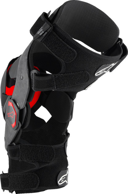 Alpinestars Supertech RK-10 Plasma knee braces in black and red, large size, with adjustable straps and protective design.