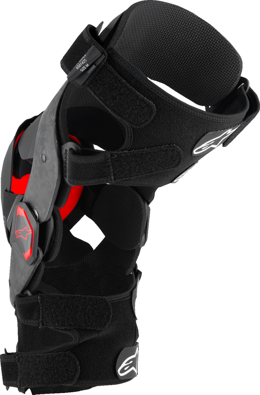 Alpinestars Supertech RK-10 Plasma knee braces in black and red, small size, with adjustable straps and protective padding.