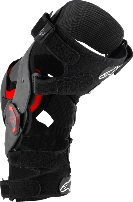 Alpinestars Supertech RK-10 Plasma knee braces in black and red, small size, with adjustable straps and protective padding.
