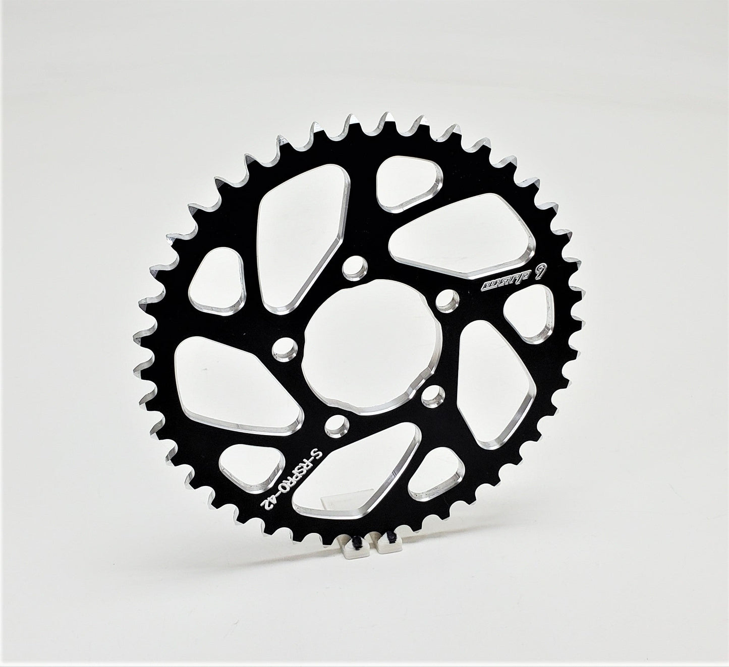 Warp 9 Racing aluminum and stainless steel rear E-Moto sprocket with 42 teeth for Surron, Talaria, and similar electric motorcycles.
