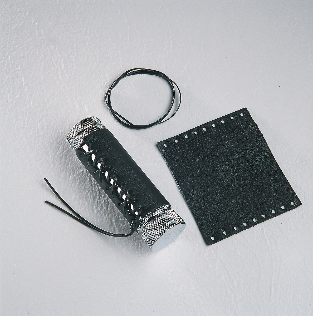 Black leather grip covers for Harley Davidson seats by Drag Specialties, featuring durable material and snug fit.
