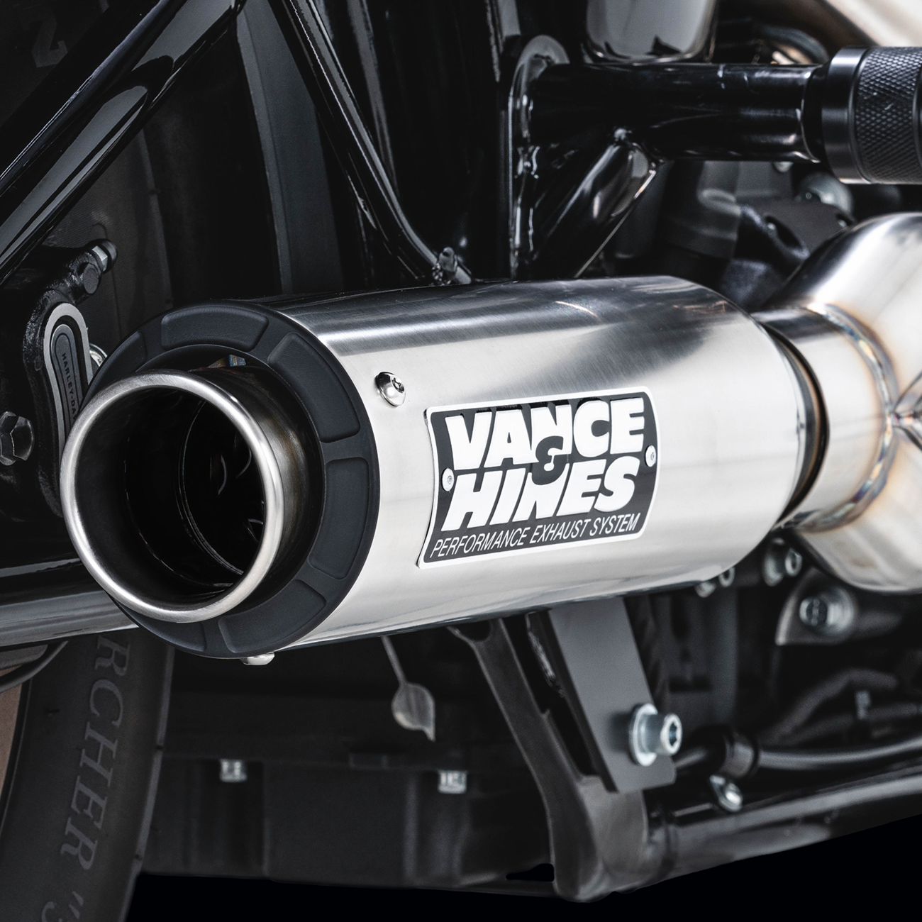 VANCE & HINES Supersport 2-Into-1 exhaust system for Softail with brushed finish, featuring sleek pipes and chrome details.